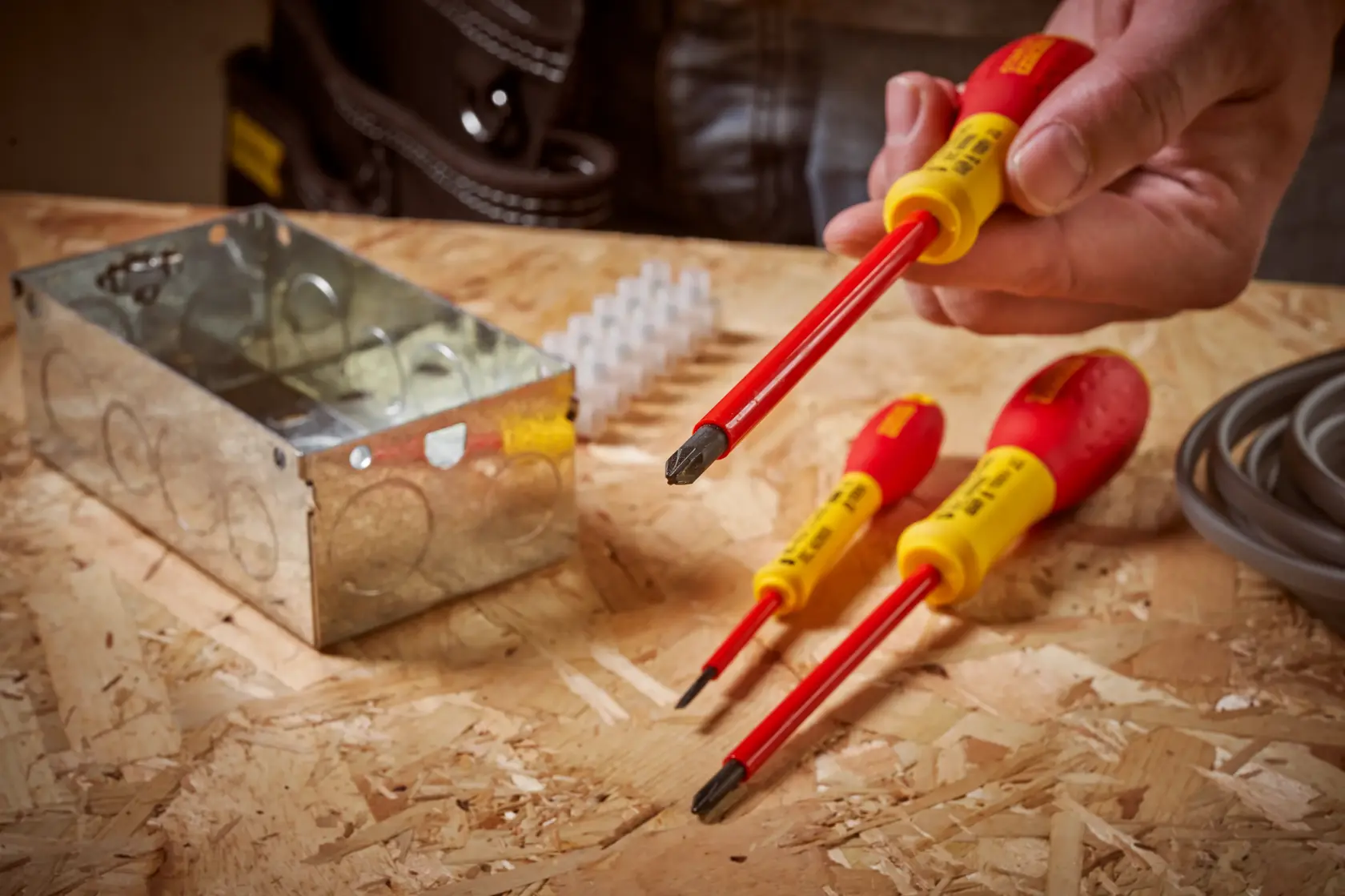 STANLEY 0-65-419 insulated screwdriver set with red and yellow handles in electrical workspace.