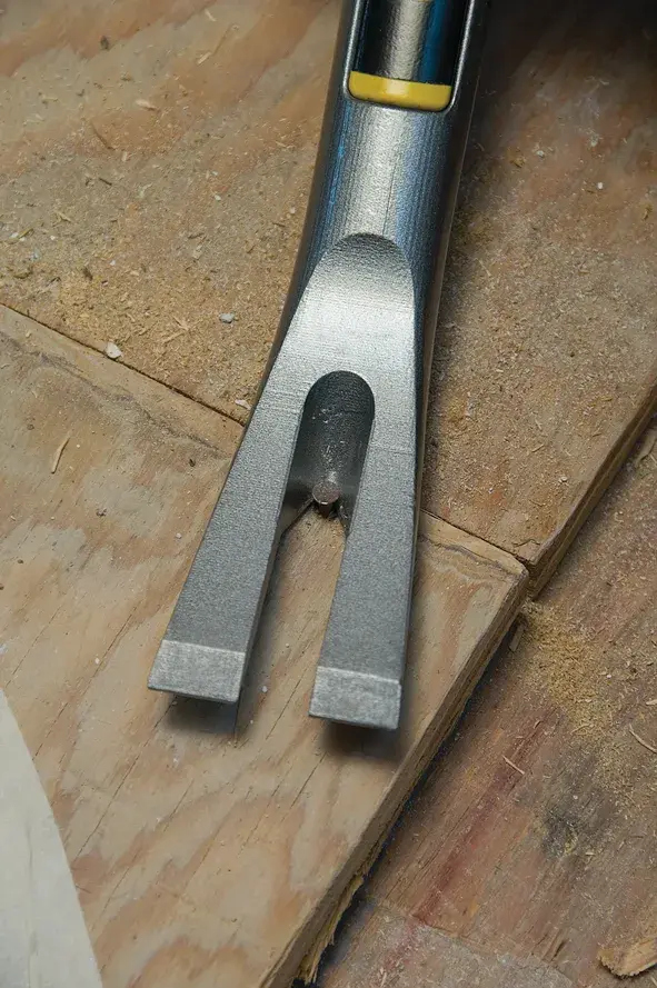STANLEY 1-55-120 pry bar close-up, steel forked end, on wooden surface.