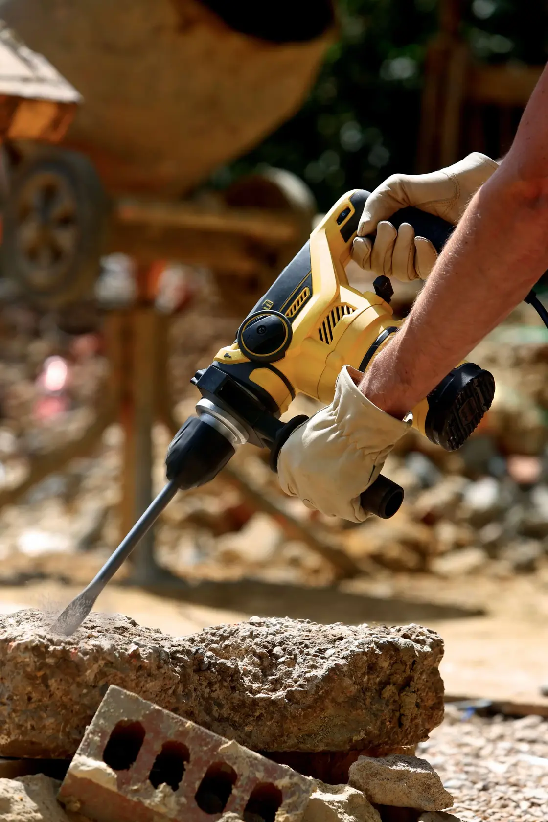 STANLEY FME1250K rotary hammer drill in use on concrete at construction site, close-up photography.