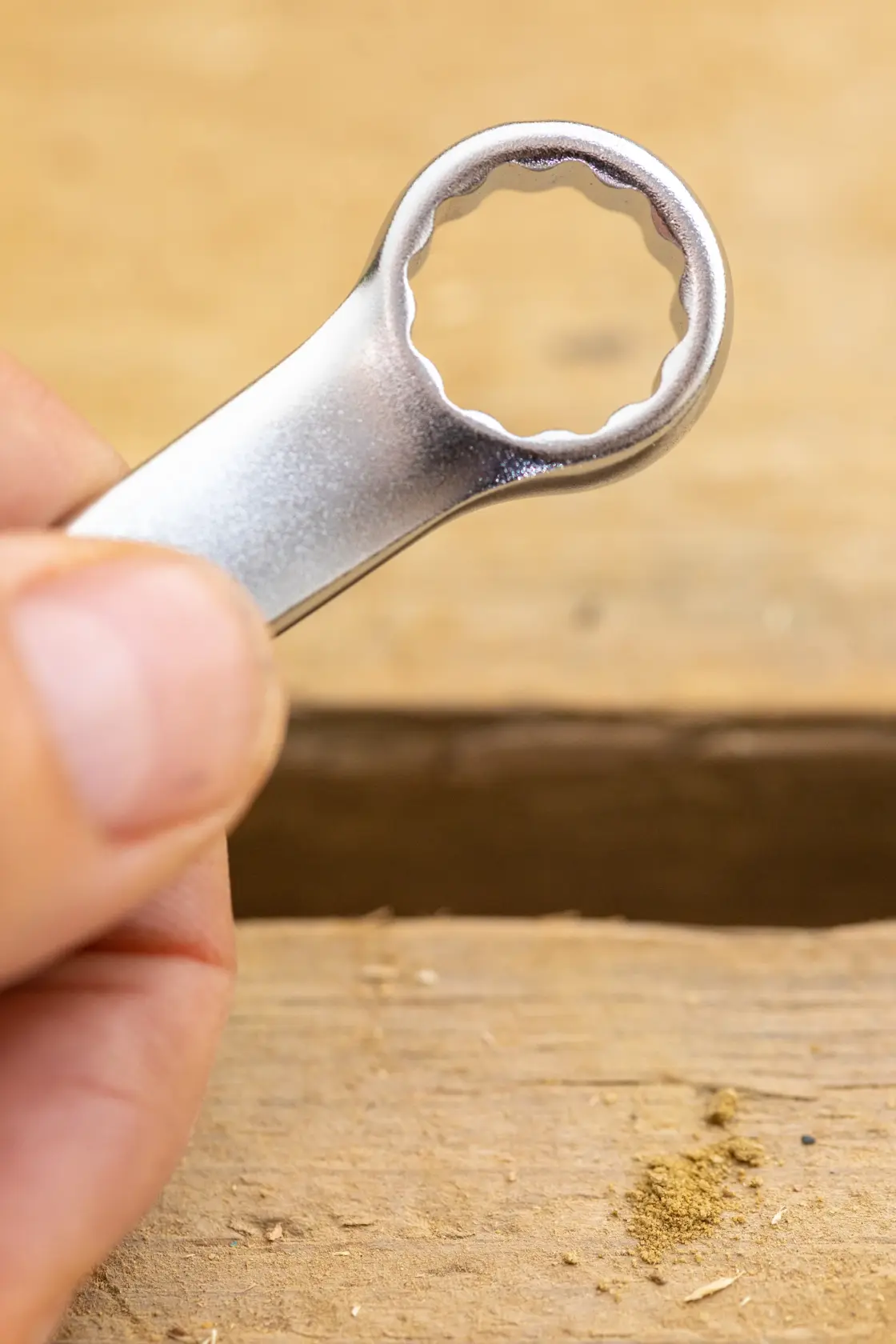 Photo of STANLEY FMMT13041-0 box-end wrench held by hand, close-up on metallic finish.
