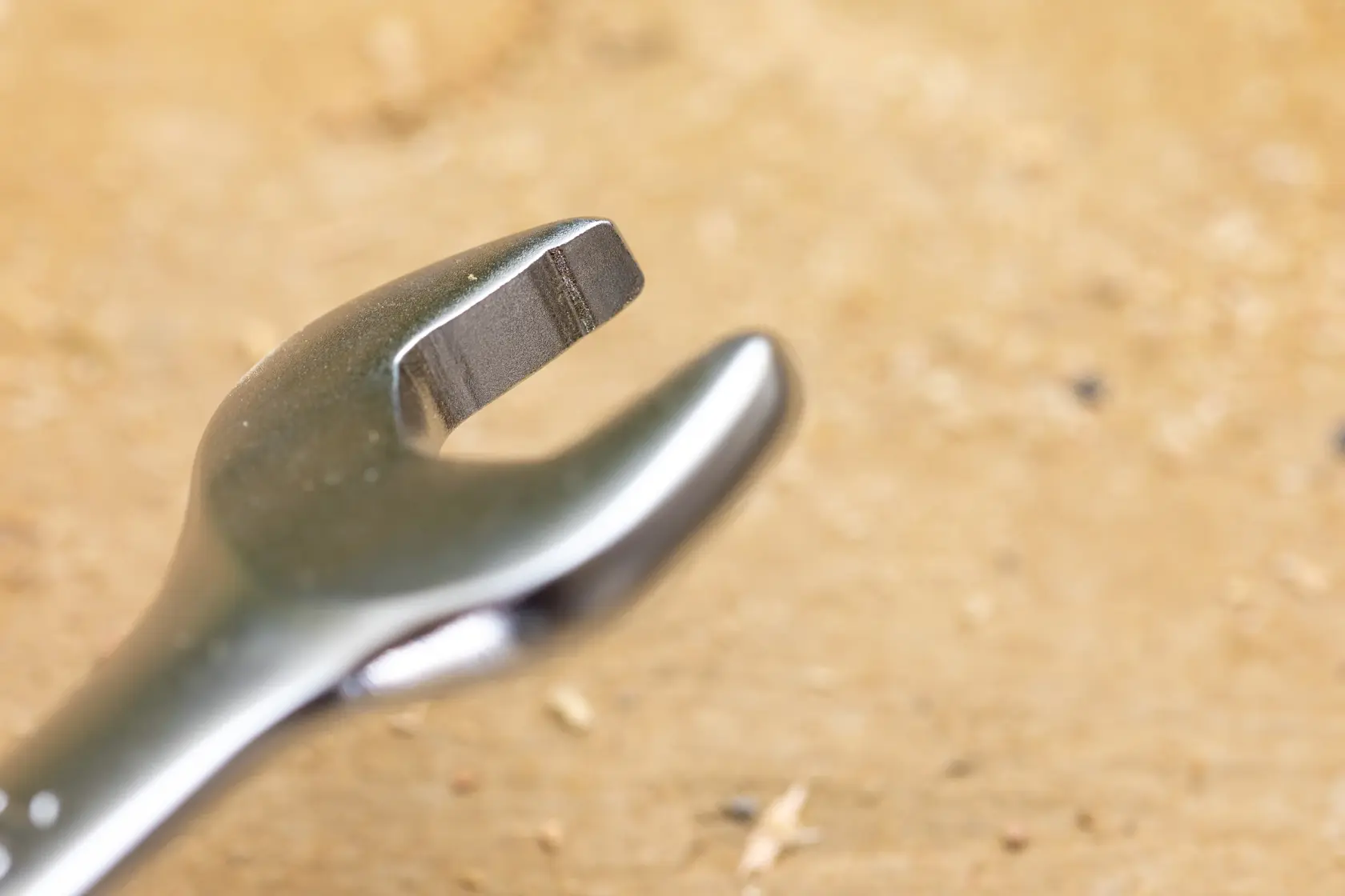STANLEY FMMT13077-0 close-up photography of open-end wrench tip, metallic finish, on wood surface.