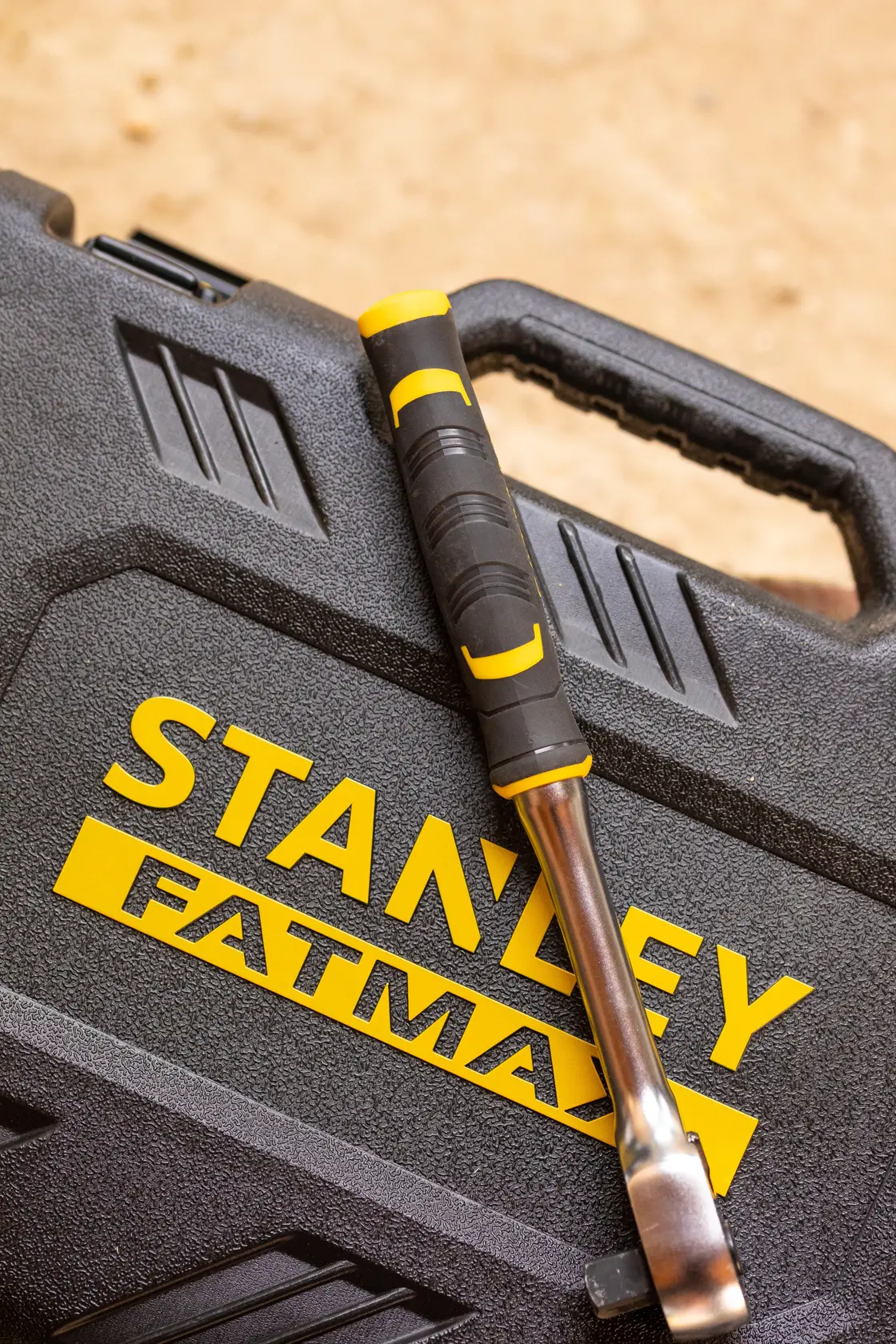 Photo of STANLEY FMMT82827-1 tool case with a black and yellow handled tool resting on top.