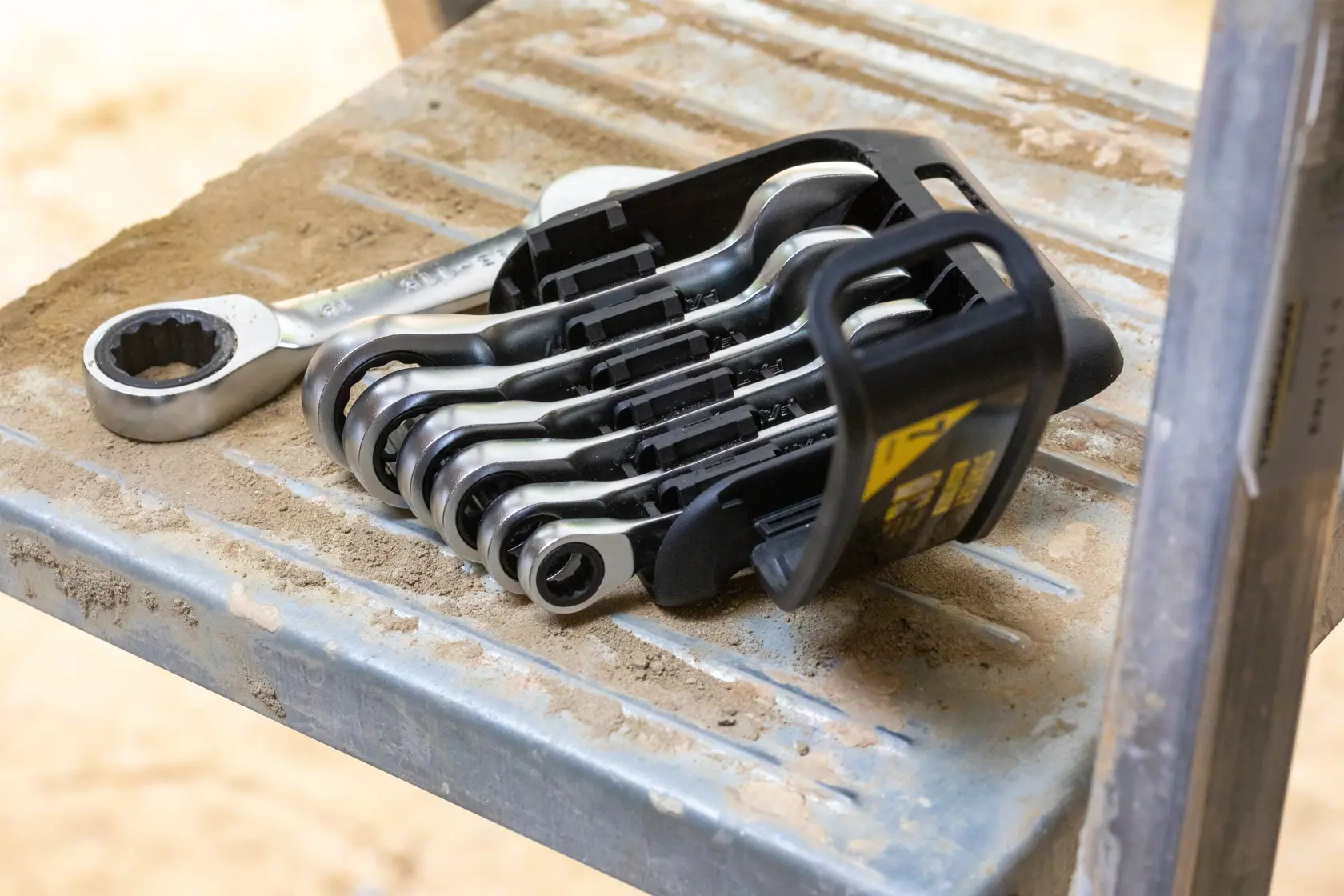 STANLEY FMMT82900-0 ratcheting wrench set in plastic holder on a dusty metal surface.