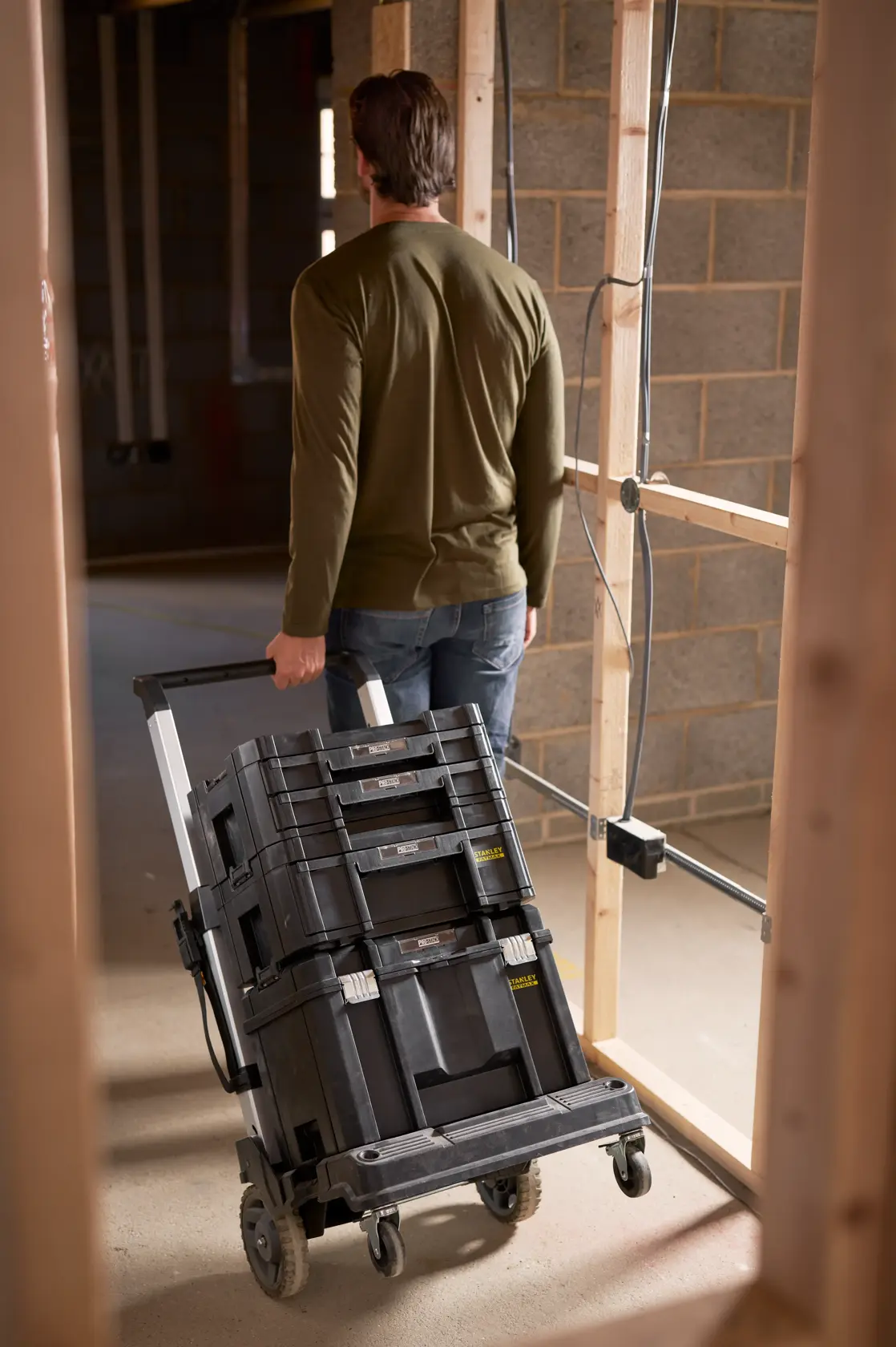 STANLEY FMST1-72363 rolling tool box stack on cart in construction site, rear view.