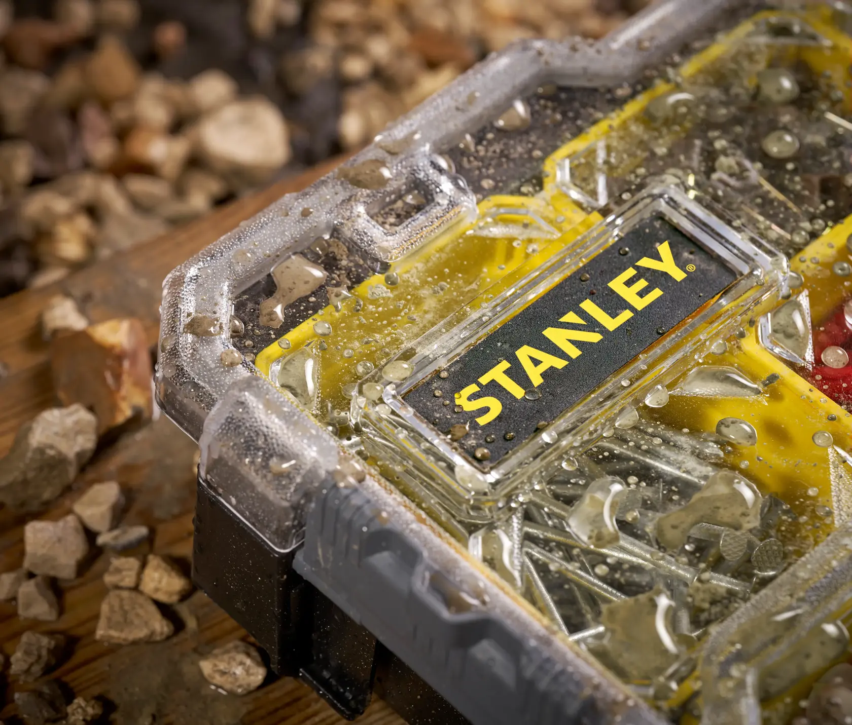 STANLEY FMST1-75779 organizer with water droplets on transparent lid, close-up view, yellow and black design.