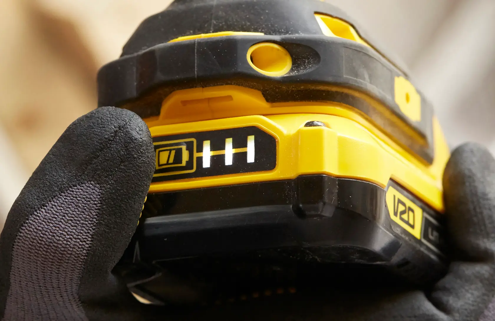 Close-up photo of STANLEY SFMCF800C2K tool battery pack with V20 label and battery indicator in use.