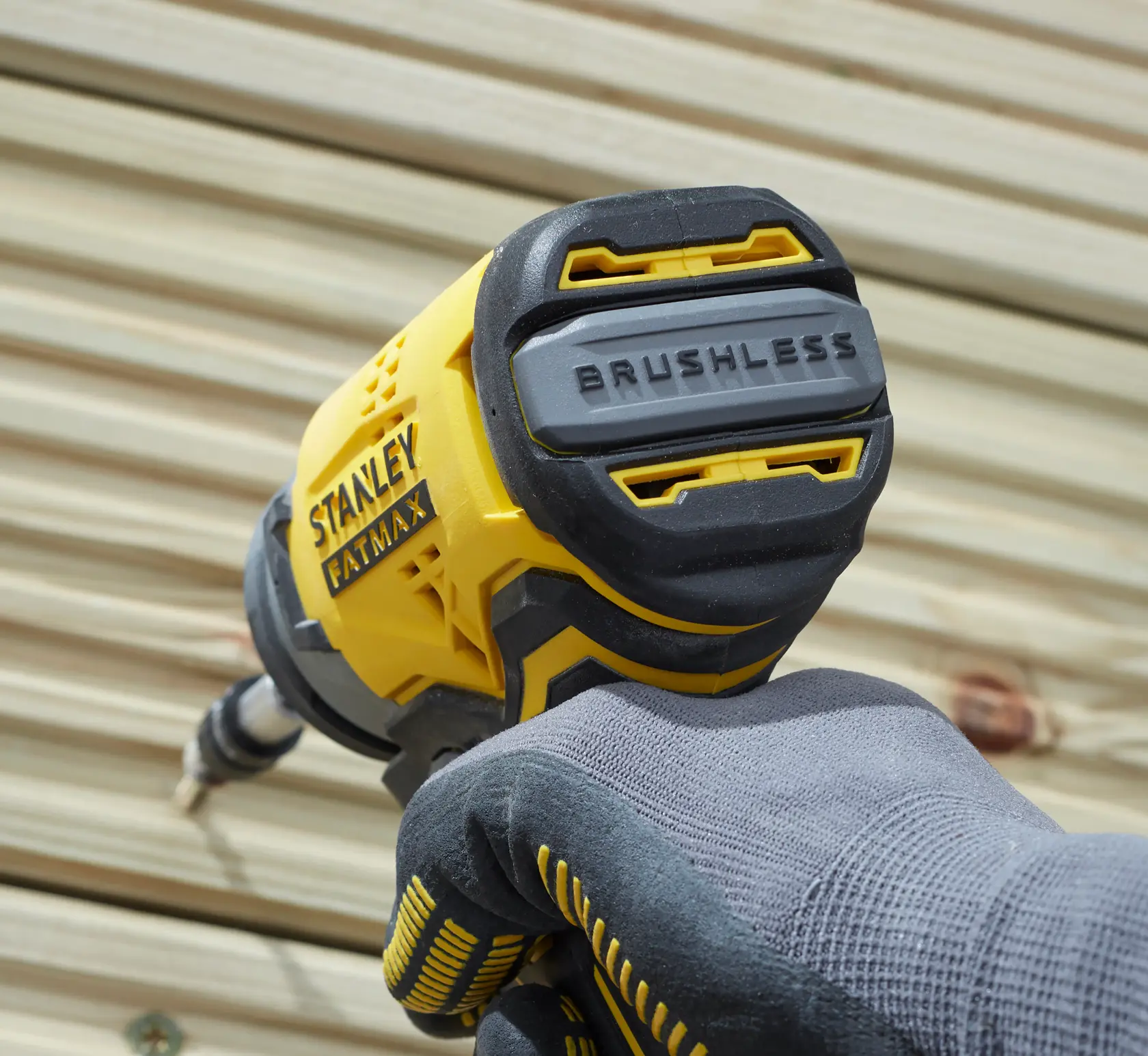 STANLEY SFMCF820D2K impact driver, brushless, close-up in use, yellow and black casing.