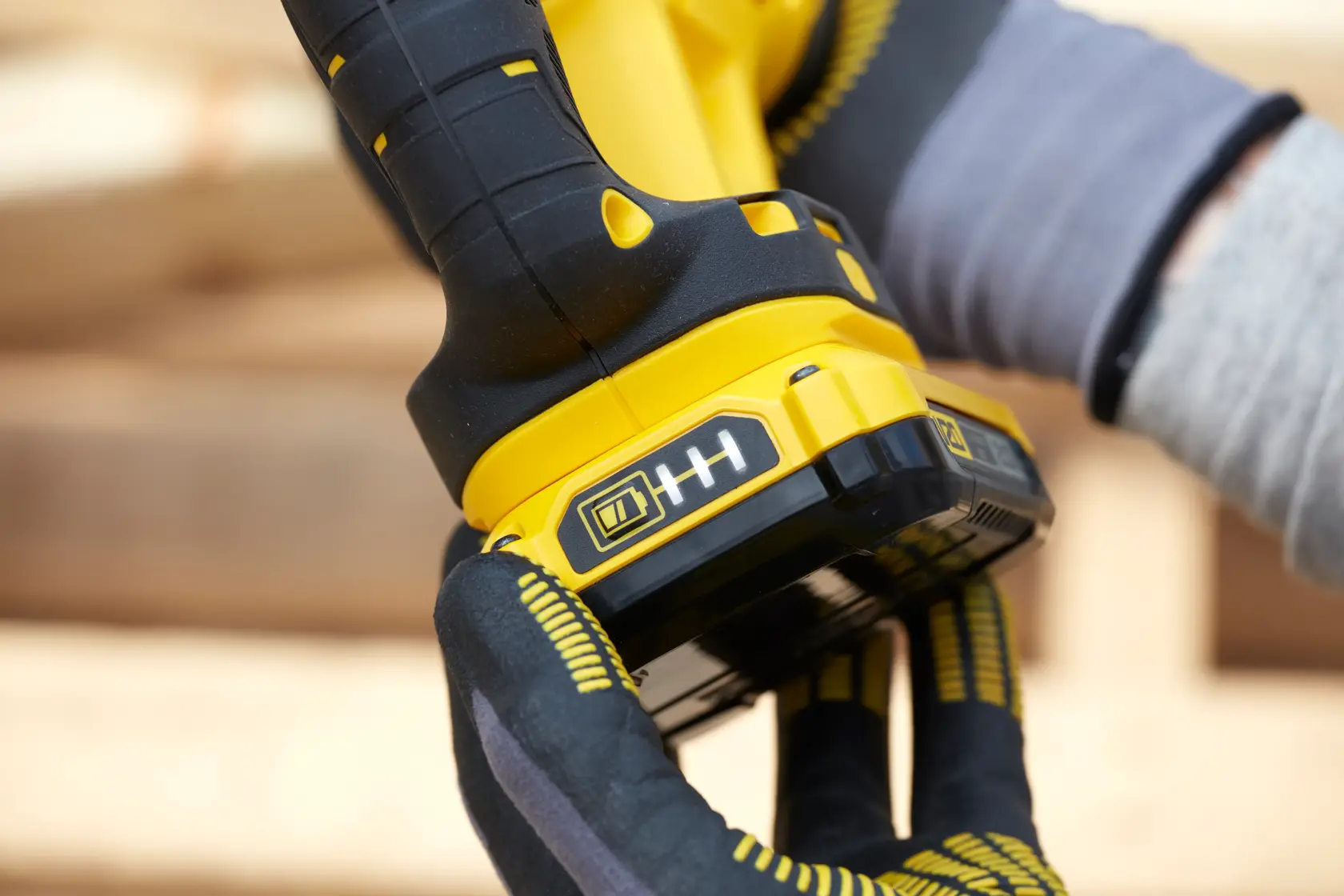 Photo of a STANLEY SFMCS300D2K cordless tool handle and battery in use, close-up view.