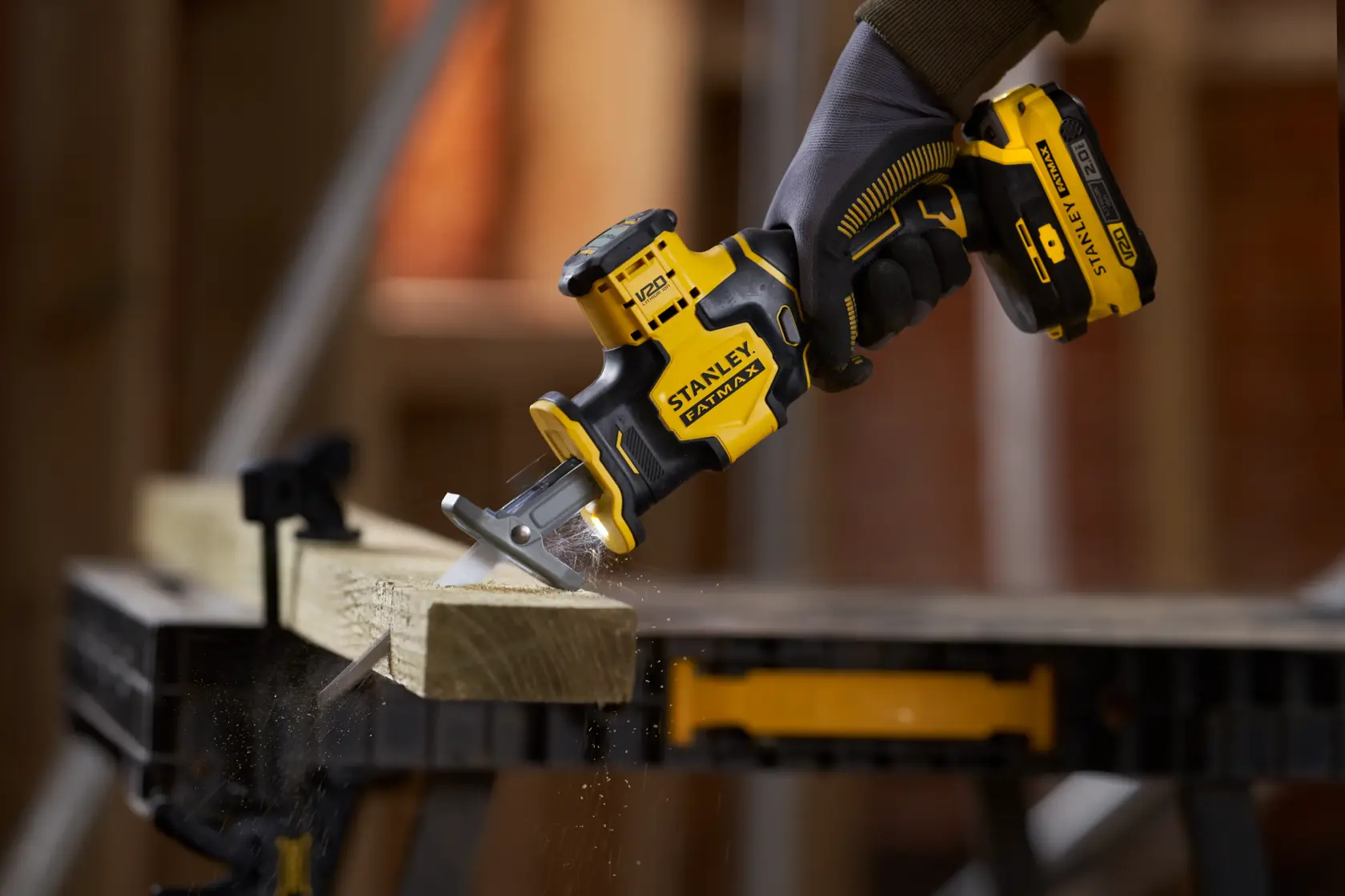 STANLEY SFMCS305B cordless reciprocating saw cutting wood, close-up photography of product in use.