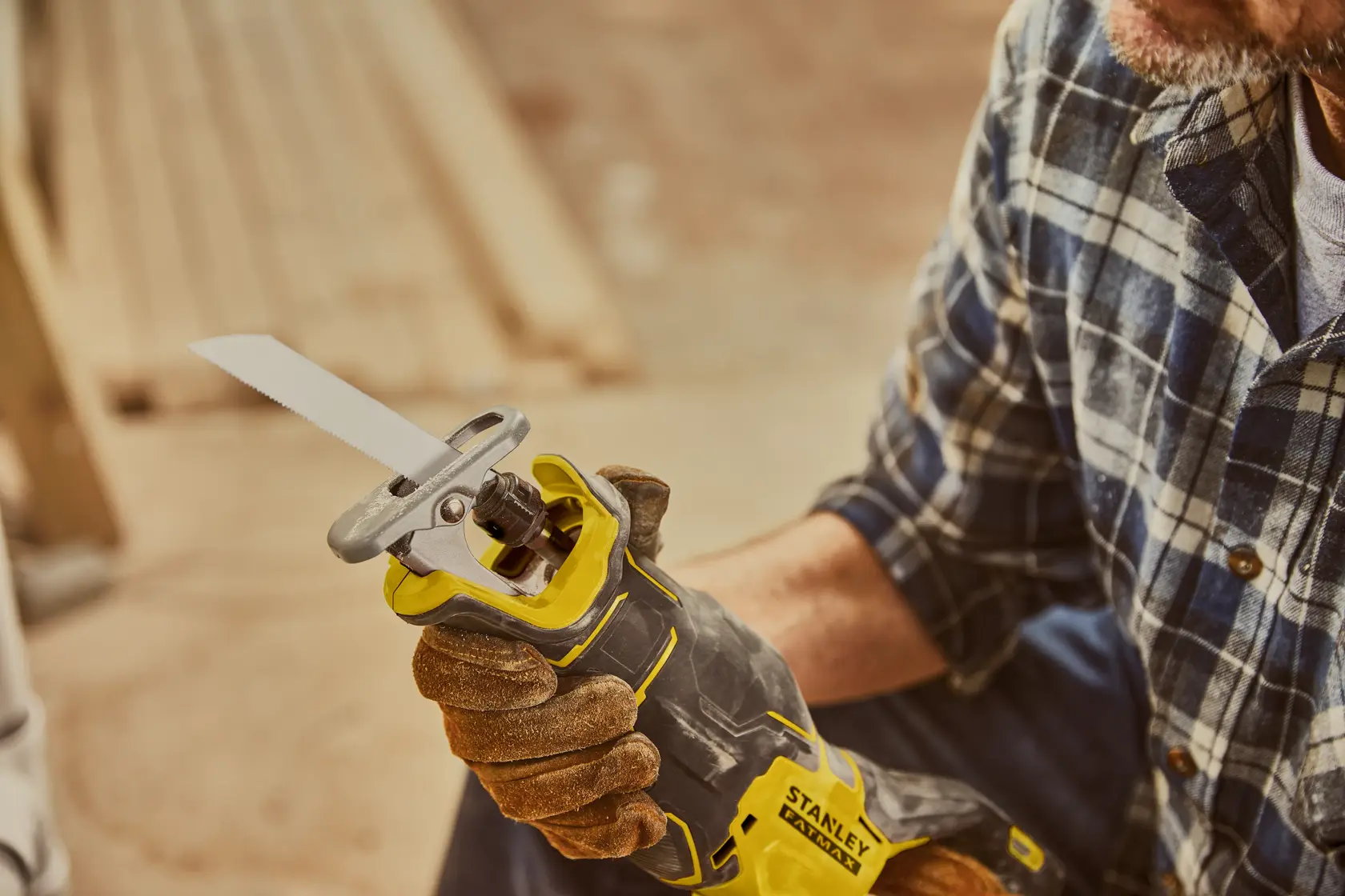 STANLEY SFMCS310B reciprocating saw held by gloved hand, close-up view photo.