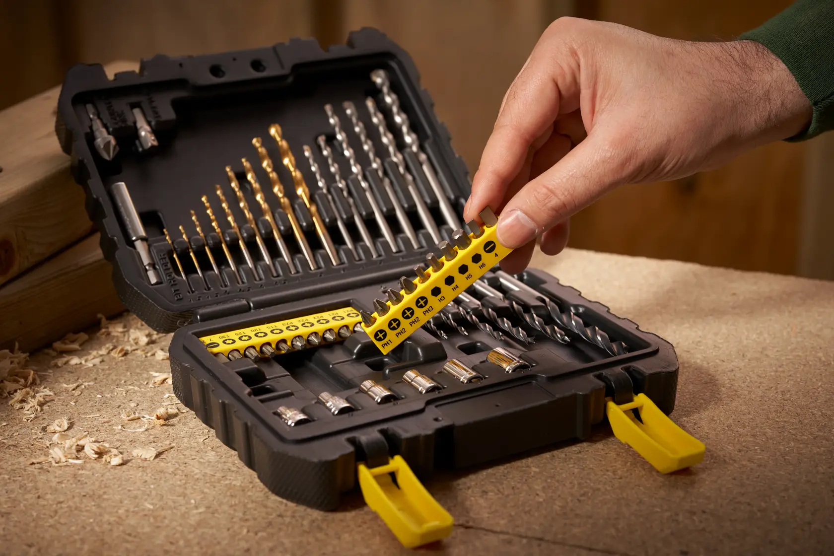 STANLEY STA88546 drill and bit set in black case, photography of hand selecting yellow bit holder.