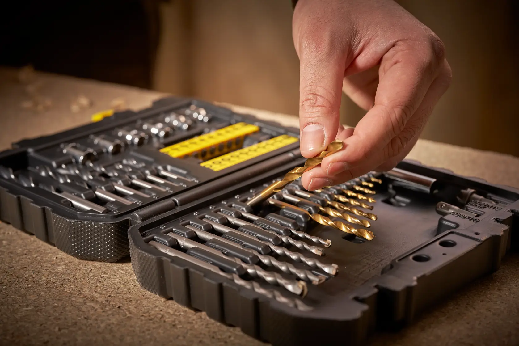 STANLEY STA88546 drill bit set in black case, close-up angled view, hand selecting gold bit.