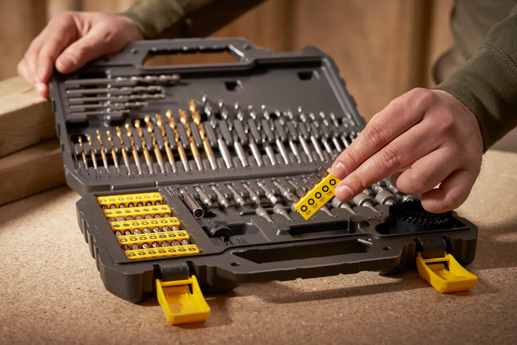 STANLEY STA88548 drill and screwdriver bit set in open case, yellow and black, photography with hand.