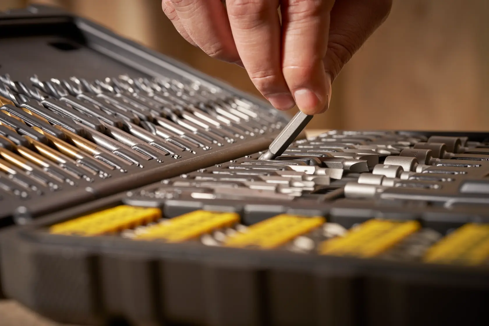 STANLEY STA88548 drill and bit set in black case, close-up with hand selecting a bit.