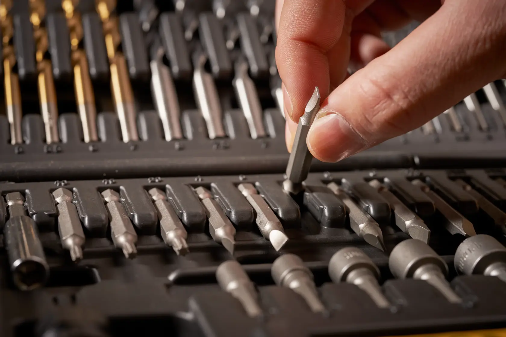 STANLEY STA88548 photography of hand selecting screwdriver bit from drill bit and driver set.