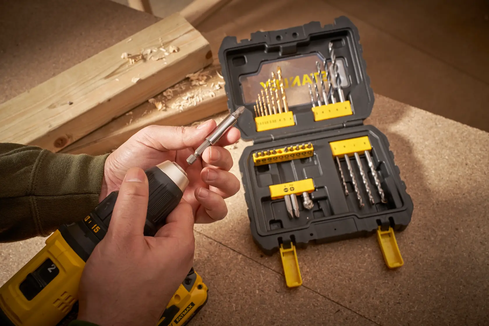 Photo of STANLEY STA88550 drill bit set in black and yellow case with various bits on a workbench.