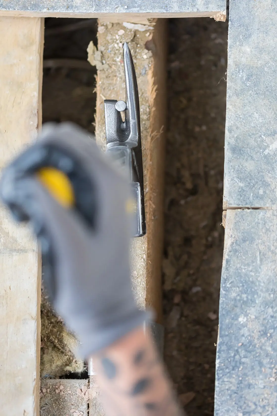STANLEY STHT0-51311 hammer with nail shown on construction site floor, overhead angle.